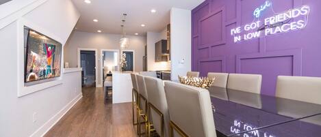 Formal dining area with smart TV connects to bright and spacious kitchen.