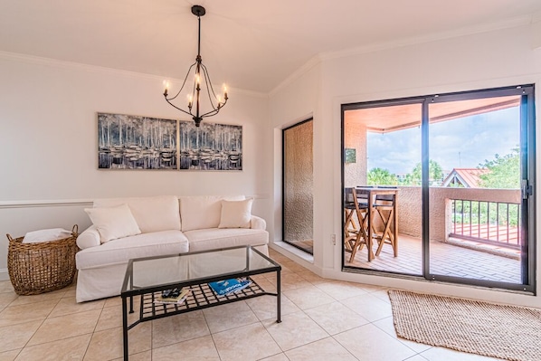 Living Room which has a sliding glass door that goes out to the Balcony.