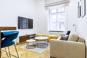 Living room with dining area, smart TV and foldable sofa