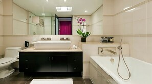 Bathroom with a shower and tub. The essential toiletries and towels are provided