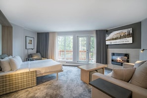 A spacious and inviting living room with cozy furnishings and a touch of natural charm, ideal for unwinding after a long day.