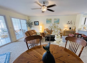Comfortable airy living area with ample sitting, beach theme deco