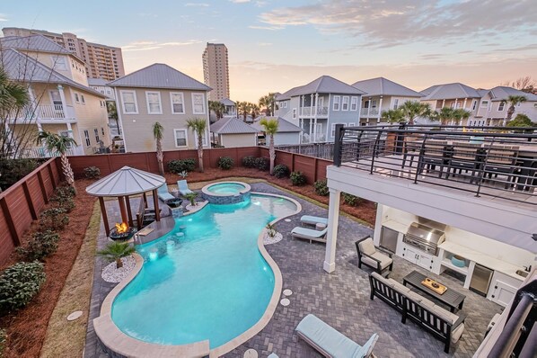 Luxurious heated swimming pool with a swim-up bar and a sitting spa.