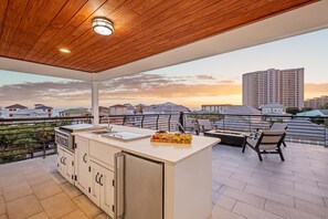 Rooftop terrace with Gulf views, gas fire pit, and a Hibachi grill.