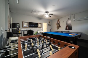 Games room with pool table, foosball, ping pong and wall mounted 55" 4K LED Samsung Smart TV