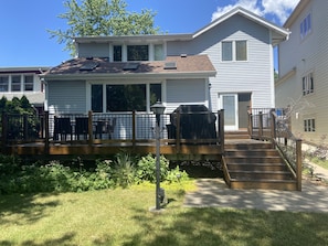 Back of house with deck/grill/patio table