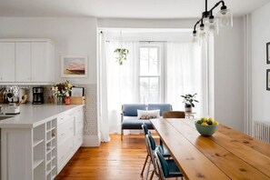 Open concept kitchen/dining room with large Harvest Table.