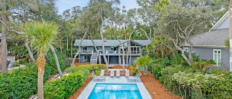 View of the backyard pool, private beach path and house