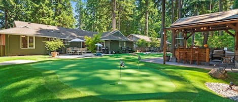 Incredible indoor / outdoor living with faux grass golf experience, gazebo, fire-pit, and tons of outdoor seating.