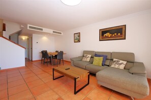 Another view of the living room with dining area to the rear