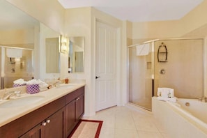Dual vanities and separate bathtub and walk-in shower in the Primary Bathroom