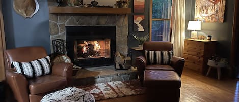 Upstairs living room with fireplace and walk-out access to upper deck