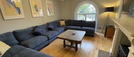 Living room with wall mounted smart tv connected to sky