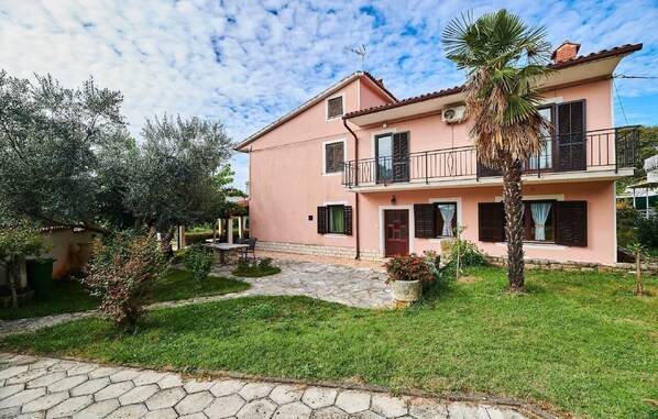 The house with a large garden decorated with plants and flowers