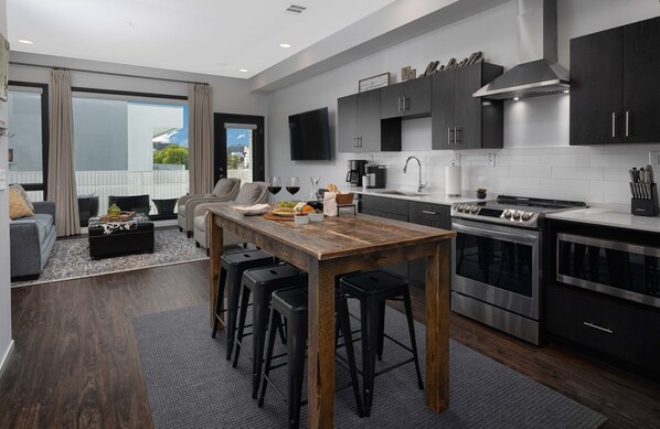 Fully stocked kitchen with stainless steel appliances and plenty of seating
