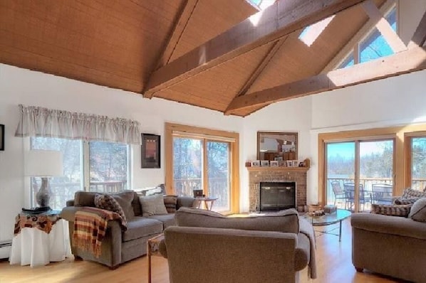 Large comfortable living room on main floor with beautiful lake views.