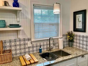 New granite countertops and new cabinets In the kitchen.