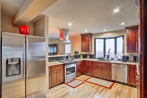 A fully-equipped kitchen with stainless appliances.