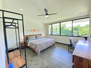 Massive bedroom with king-size bed and workstation with a view. 