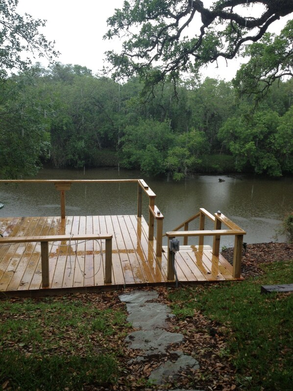 Large deck overlooking river. Private fishing dock down the stairs.