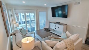 65" TV in the living room.  Chair in corner can be used at dining table.
