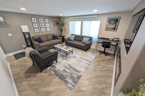 Cozy living room with desk work area. Clean Hardwood floors with enough space.