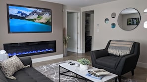 The living room includes a new Samsung 4k smart TV and electronic fireplace. 