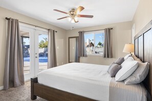 Master bedroom with french doors opening to large patio and pool