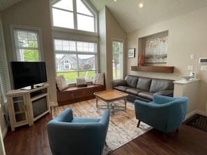 Living room with seating for 8, TV, cable, DVD, and a cozy fireplace