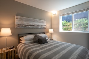 Relax in a peaceful, light-filled bedroom with views of Jasmine vine