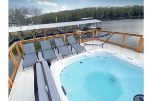 rooftop deck with a hot tub