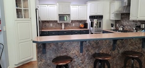 Kitchen and bar with plenty of space and options for all your culinary needs!