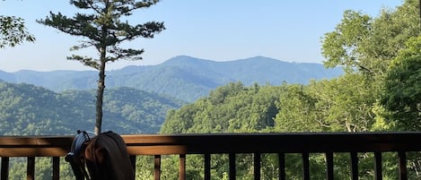 Paradise found: Serene mountain views from our cabin's enchanting deck!"