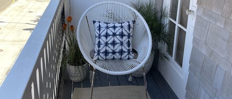 Comfy outdoor area to read or drop the shade for privacy and sun protection.