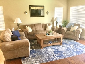 Family living room located off the kitchen area & has access to private backyard