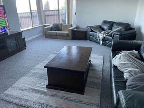Lounge room with plenty of seating, Smart TV, DVD, board games and puzzles.