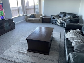 Lounge room with plenty of seating, Smart TV, DVD, board games and puzzles.