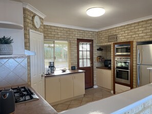 Gas hob, dishwasher, microwave, oven and grill and full-size fridge/freezer.