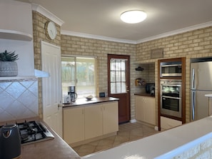 Gas hob, dishwasher, microwave, oven and grill and full-size fridge/freezer.