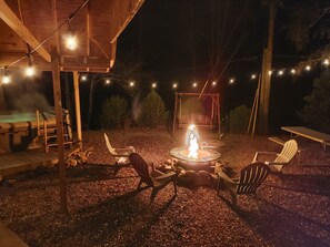 Newly expanded backyard with fire pit corn hole hot tub swings and more