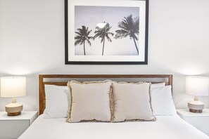 The bedroom features a king-size bed with a memory foam mattress