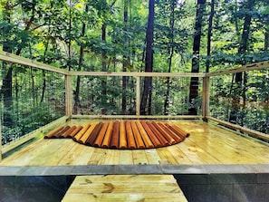 Hot tub has a cedar cover. It's so strong you can walk on it! Cover rolls off easily.