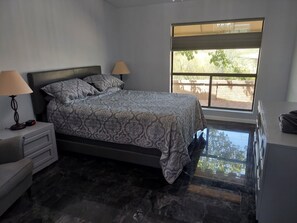Primary Master bedroom with dresser and side tables