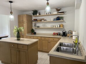 Open shelving, fully equipped kitchen.