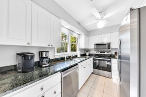 The kitchen is to your left and has updated with new granite counters, back splash, and stainless steel appliances.