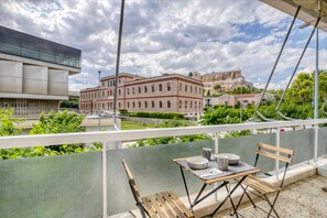 Balcony with table and chairs, to enjoy the moments! The rel view is much closer