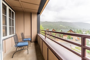 Private balcony with outdoor seating and slope views,