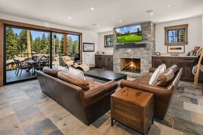 Fit for a King: - Spacious great room with a gas fireplace and large smart TV.