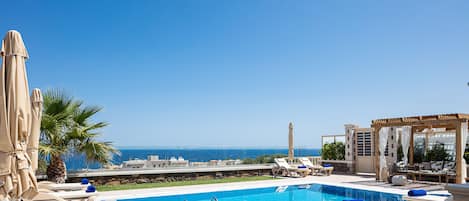 Blissfully tucked away commanding breathtaking coastal view.
