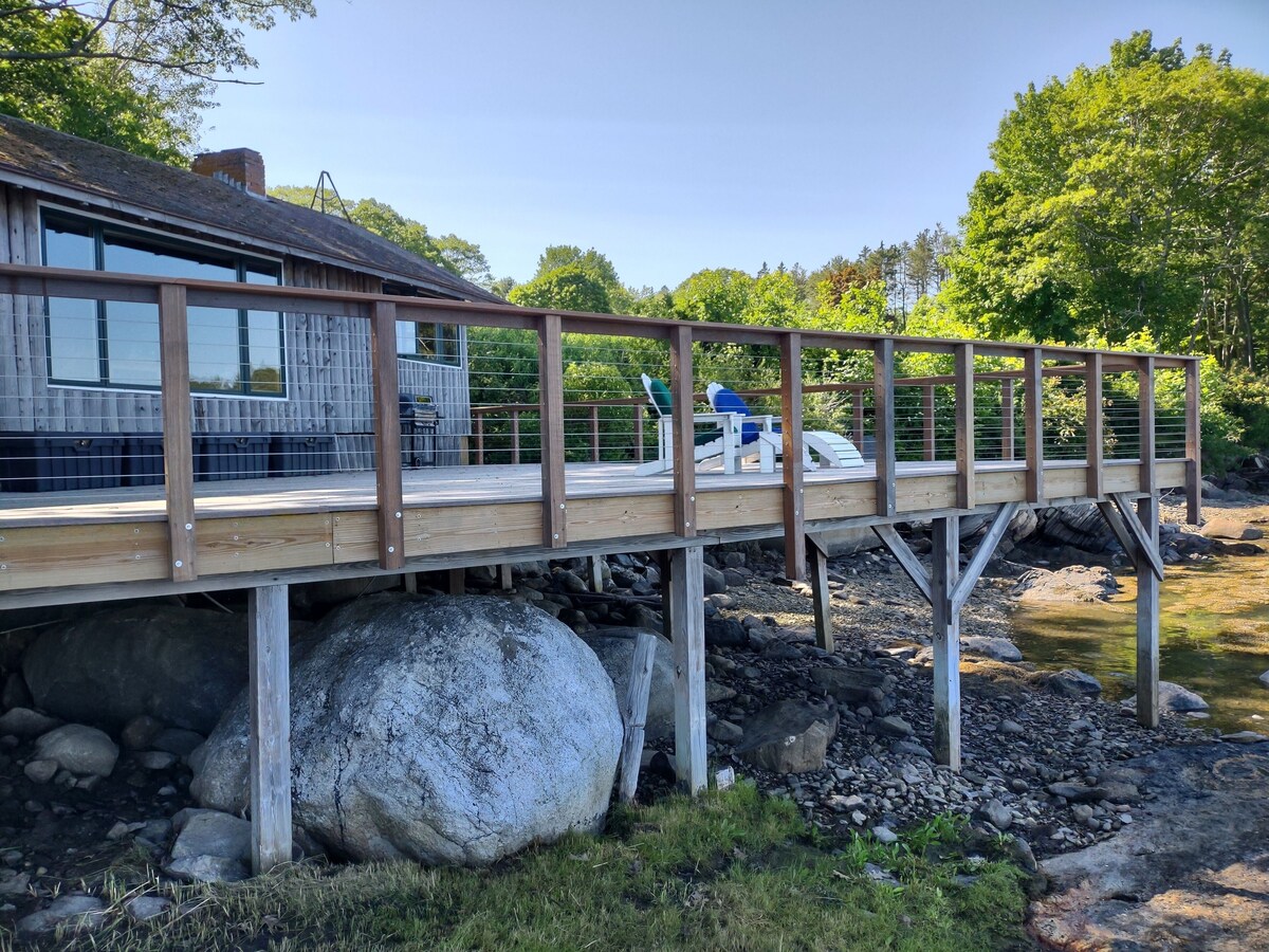 Cozy waterfront log cottage with huge outdoor living area.